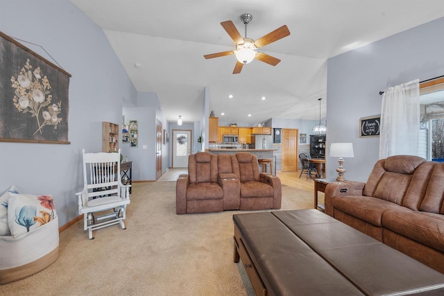 living area with high vaulted ceiling, light colored carpet, a healthy amount of sunlight, and a ceiling fan