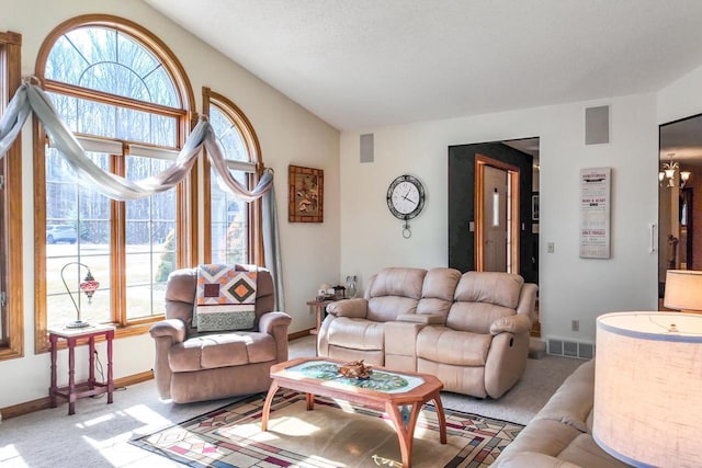 living area with a wealth of natural light, visible vents, light colored carpet, and lofted ceiling