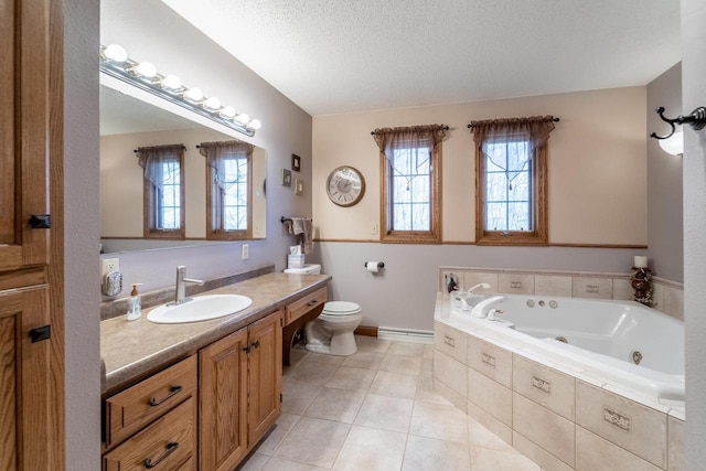 full bath with tile patterned flooring, toilet, vanity, a tub with jets, and a textured ceiling