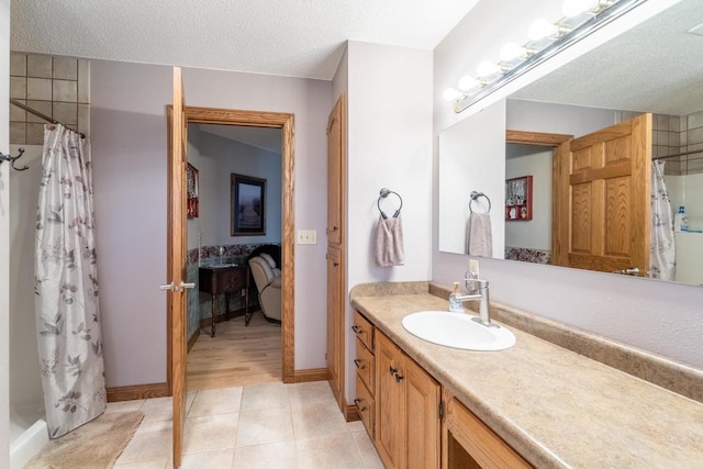 bathroom with vanity, tile patterned floors, a shower with shower curtain, and a textured ceiling