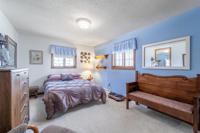 bedroom featuring carpet flooring, multiple windows, and a textured ceiling