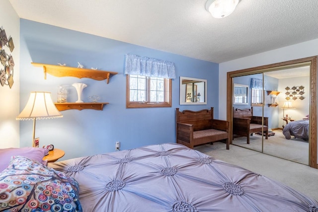 bedroom with a closet, a textured ceiling, and carpet