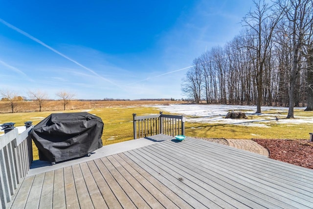 wooden terrace with a yard and a grill