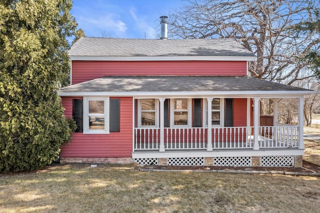 view of front of property with roof with shingles, a porch, and a front lawn