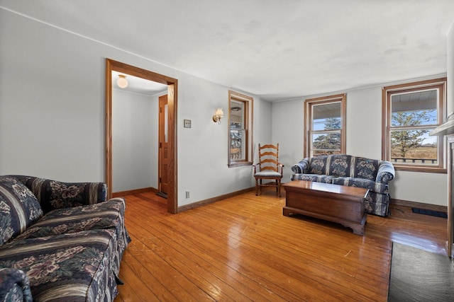 living area featuring light wood finished floors and baseboards