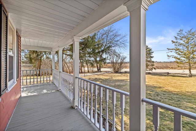 deck with a yard and a porch