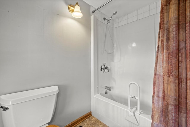 bathroom with toilet, shower / tub combo, and baseboards