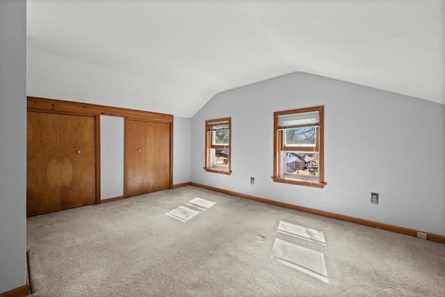 bonus room featuring vaulted ceiling, baseboards, and light carpet