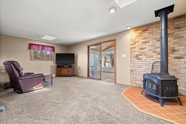 carpeted living area with a wood stove