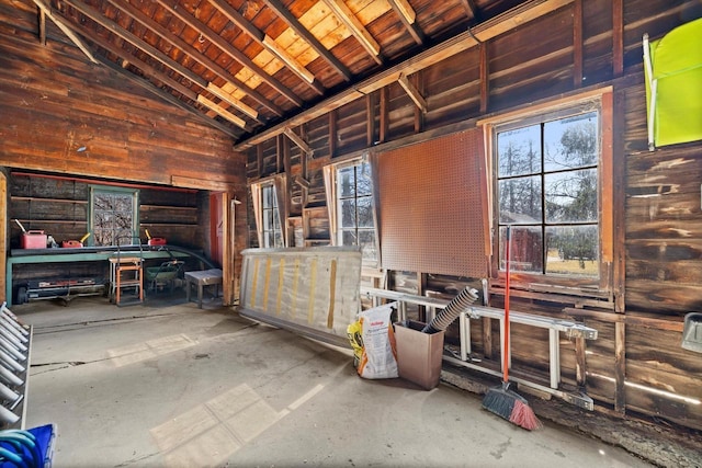 misc room with wooden ceiling, wooden walls, and high vaulted ceiling