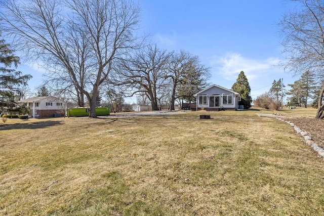 view of yard featuring a sunroom