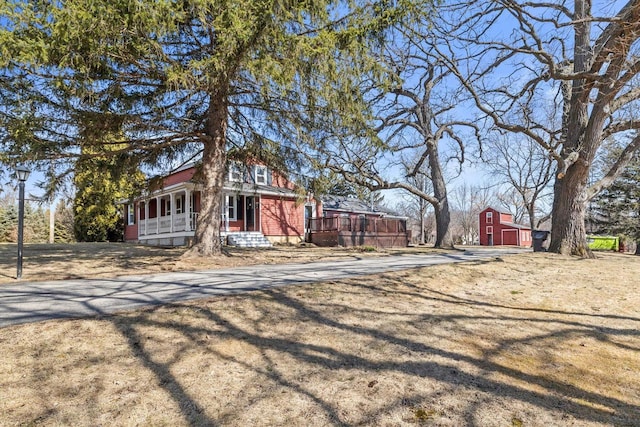 exterior space with an outbuilding, a barn, and a porch