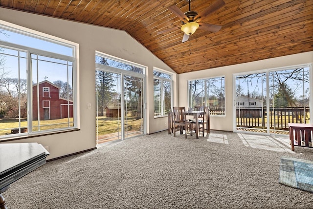 unfurnished sunroom featuring ceiling fan, wooden ceiling, and vaulted ceiling