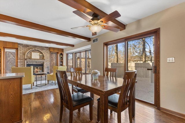 dining area with visible vents, beamed ceiling, dark wood-style flooring, and a ceiling fan