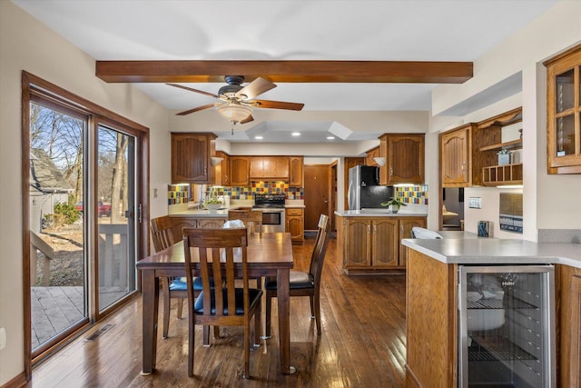 dining space featuring wine cooler, visible vents, beamed ceiling, and dark wood-style floors