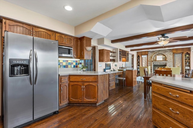 kitchen featuring brown cabinets, appliances with stainless steel finishes, light countertops, and open shelves