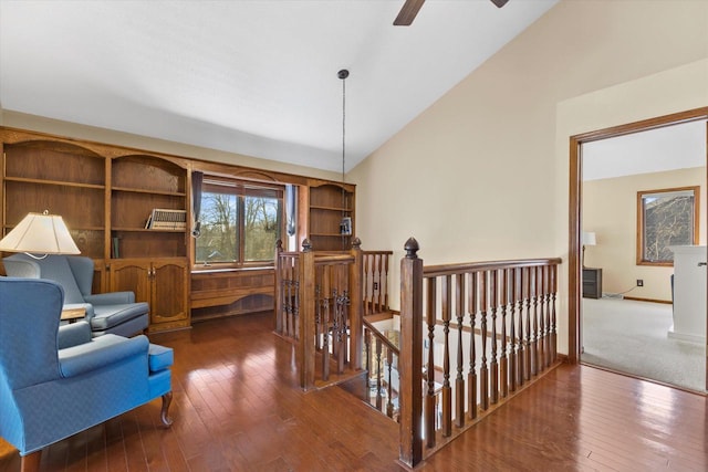 sitting room featuring an upstairs landing, high vaulted ceiling, hardwood / wood-style flooring, baseboards, and ceiling fan