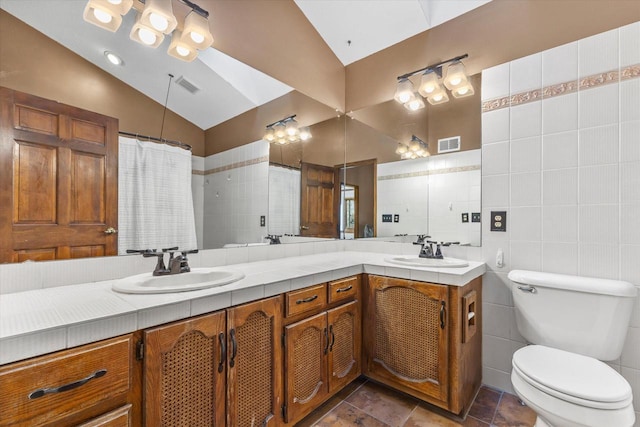 bathroom featuring vaulted ceiling, visible vents, toilet, and a sink