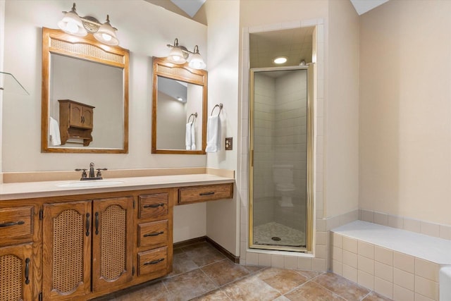 full bath with tile patterned floors, a stall shower, and vanity