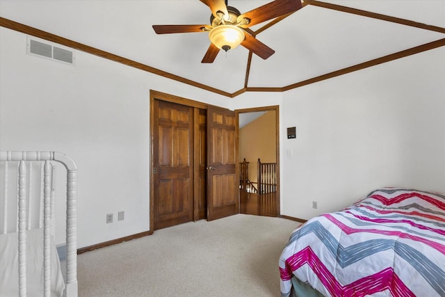 carpeted bedroom featuring a ceiling fan, baseboards, visible vents, and ornamental molding