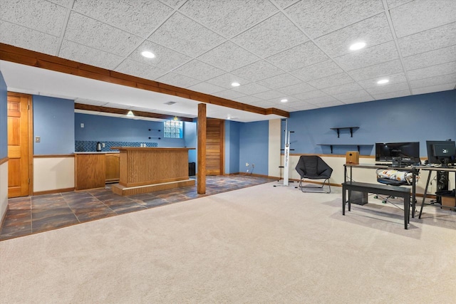 interior space featuring indoor wet bar, recessed lighting, dark carpet, and baseboards