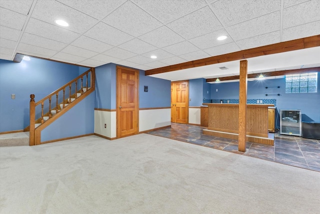 interior space with baseboards, carpet, wine cooler, stairs, and indoor wet bar