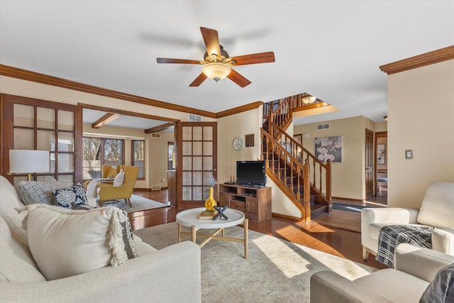 living area with wood finished floors, visible vents, stairs, french doors, and crown molding