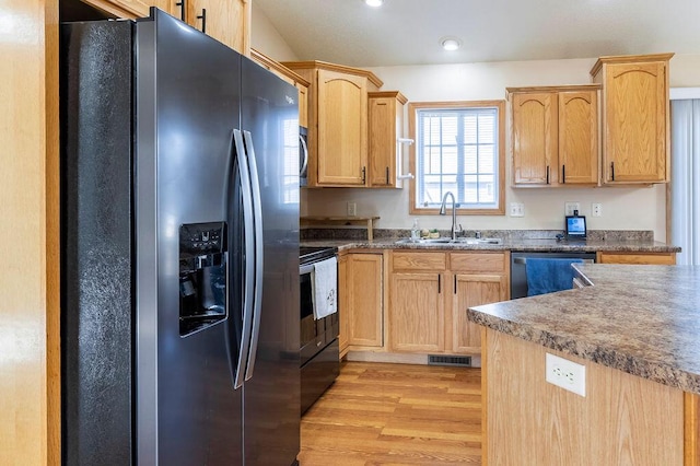 kitchen featuring light wood-type flooring, electric stove, a sink, black fridge with ice dispenser, and dishwasher