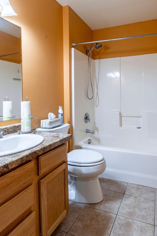 bathroom featuring tile patterned floors, shower / bathtub combination, toilet, and vanity