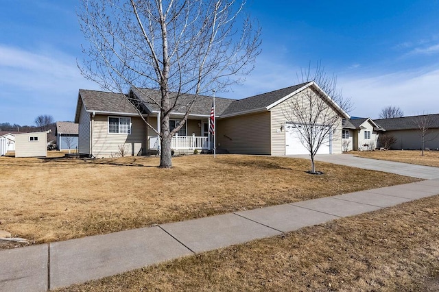 ranch-style home with a front lawn, a shed, a porch, driveway, and an attached garage