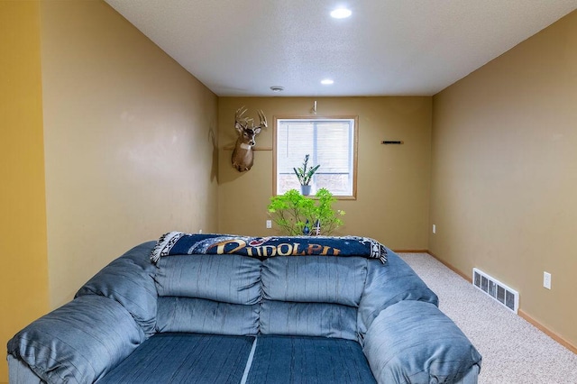 living area with carpet, visible vents, baseboards, recessed lighting, and a textured ceiling