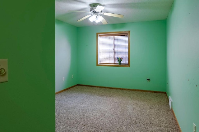 spare room with visible vents, baseboards, carpet, and ceiling fan