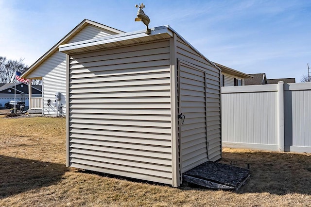 view of outdoor structure with an outbuilding and fence