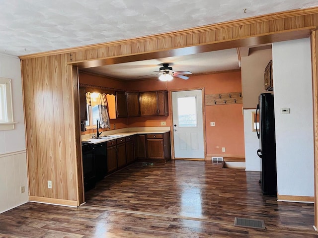 kitchen featuring visible vents, dark wood-type flooring, a ceiling fan, a sink, and light countertops