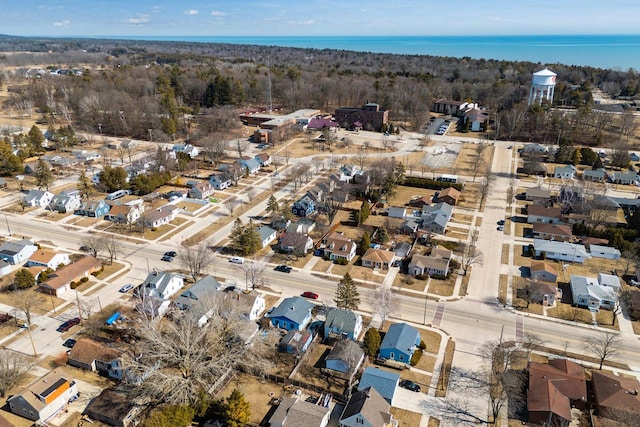 drone / aerial view featuring a residential view and a water view