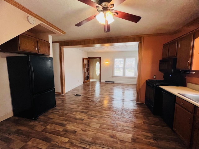 kitchen featuring black appliances, dark wood-style floors, open floor plan, light countertops, and ceiling fan