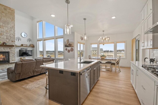 655 Sunset Grn, Bay, WI 54313 - kitchen with an inviting chandelier, a sink, light countertops, light wood-style floors, and appliances with stainless steel finishes
