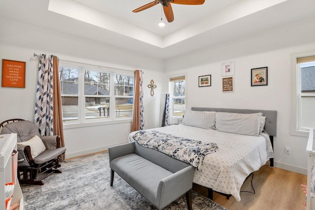 655 Sunset Grn, Bay, WI 54313 - bedroom featuring a ceiling fan, wood finished floors, baseboards, recessed lighting, and a raised ceiling