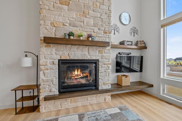 655 Sunset Grn, Bay, WI 54313 - details with a fireplace, wood finished floors, visible vents, and baseboards