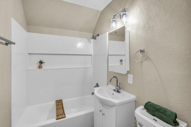 full bath featuring toilet, shower / bath combination, lofted ceiling, vanity, and a textured wall