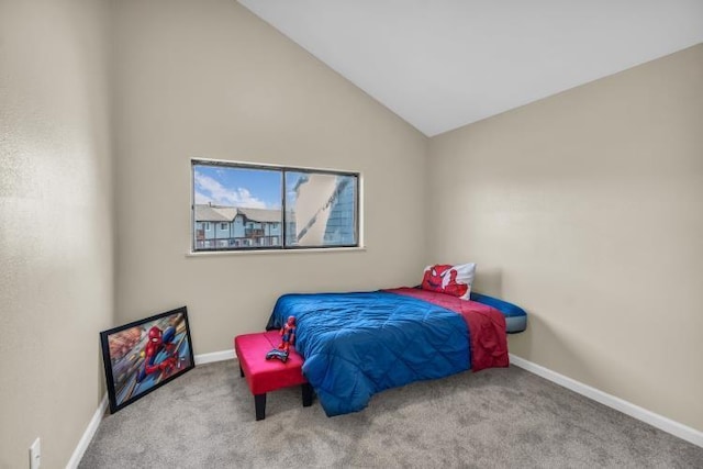 carpeted bedroom featuring baseboards and vaulted ceiling