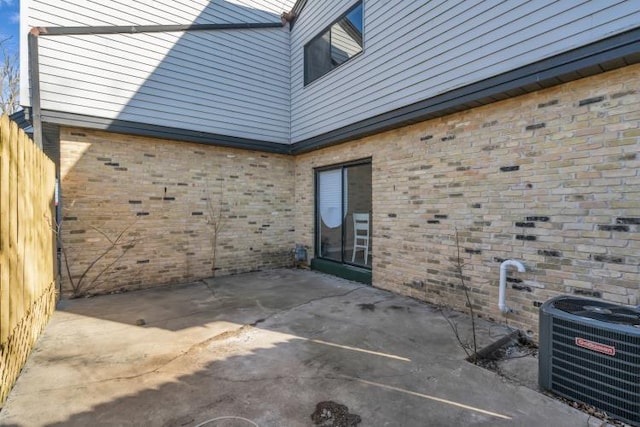 view of patio with central air condition unit and fence