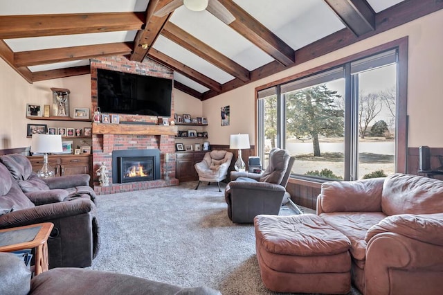 living area with vaulted ceiling with beams, a fireplace, and carpet floors