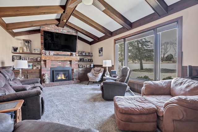 carpeted living area featuring vaulted ceiling with beams and a fireplace