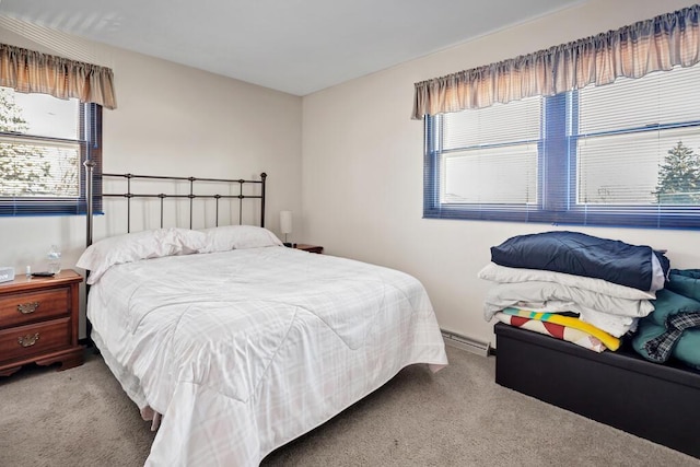 carpeted bedroom with a baseboard heating unit