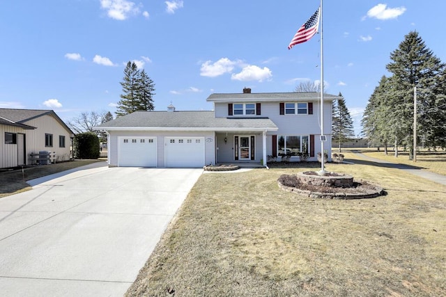 traditional home with a front lawn, a chimney, concrete driveway, and an attached garage