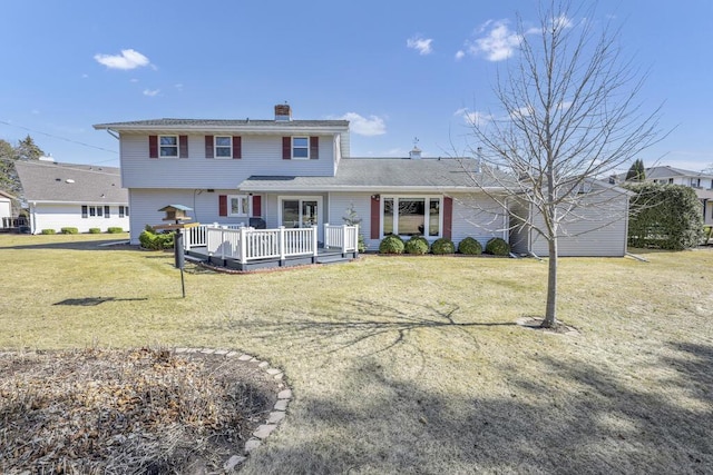 view of front of property with a wooden deck, a front lawn, and a chimney