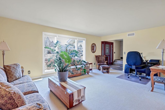 carpeted living room featuring visible vents and baseboards