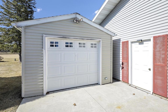 garage featuring concrete driveway