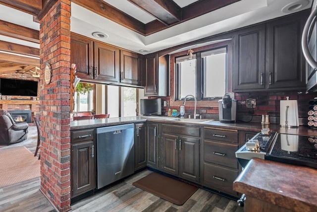 kitchen with plenty of natural light, dishwasher, wood finished floors, and a sink